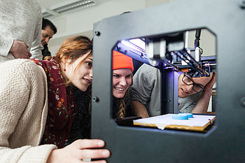 Students at a 3D printer